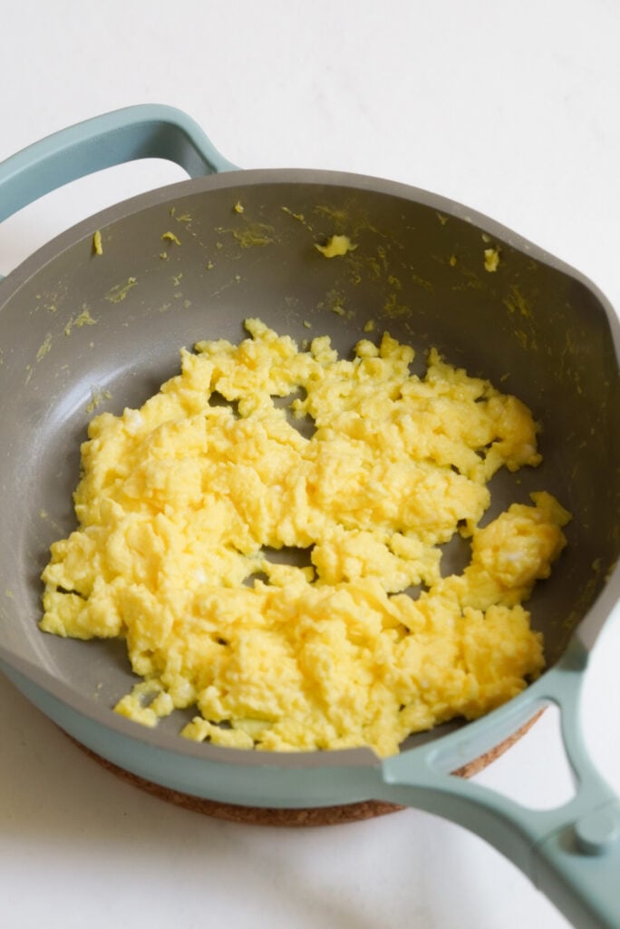 the scrambled eggs and cottage cheese have turned into a cohesive scramble. 