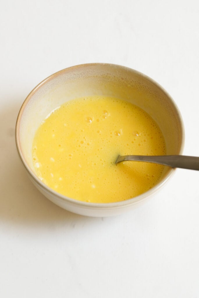 fork in the bowl of whisked eggs and cottage cheese. 