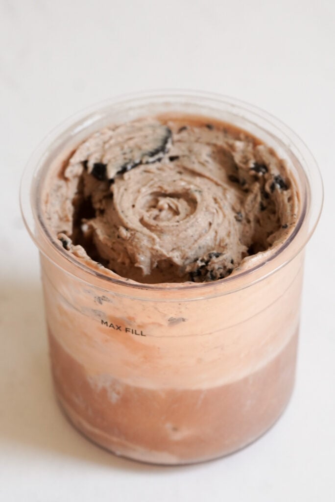 ninja creami chocolate protein ice cream with cookies in the pint container