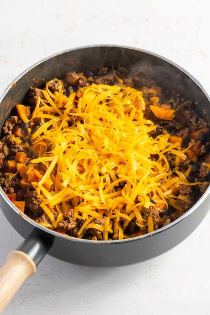 fresh yellow cheddar shreds added on top of the skillet off the heat.