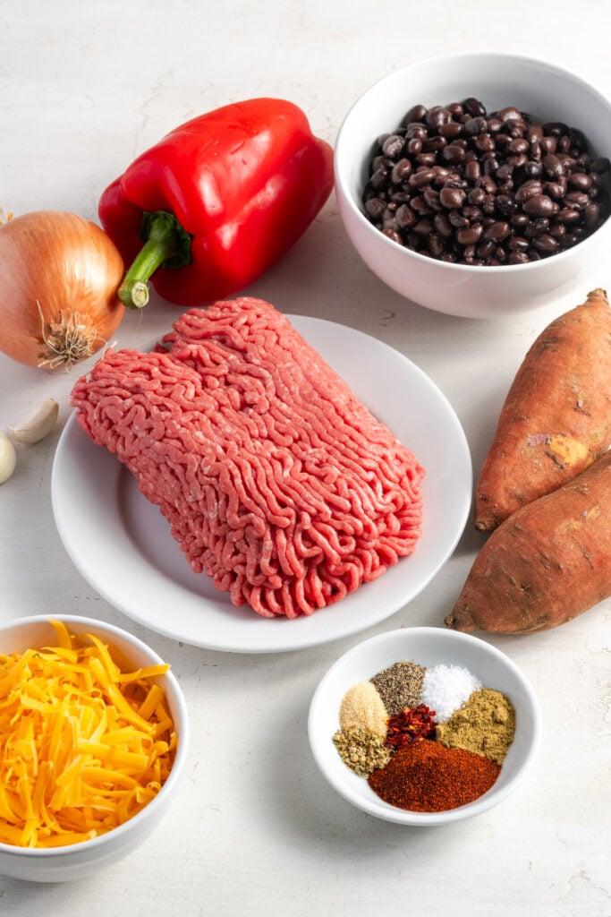 ingredients needed to make a southwestern ground beef and sweet potato skillet with black beans and cheese.