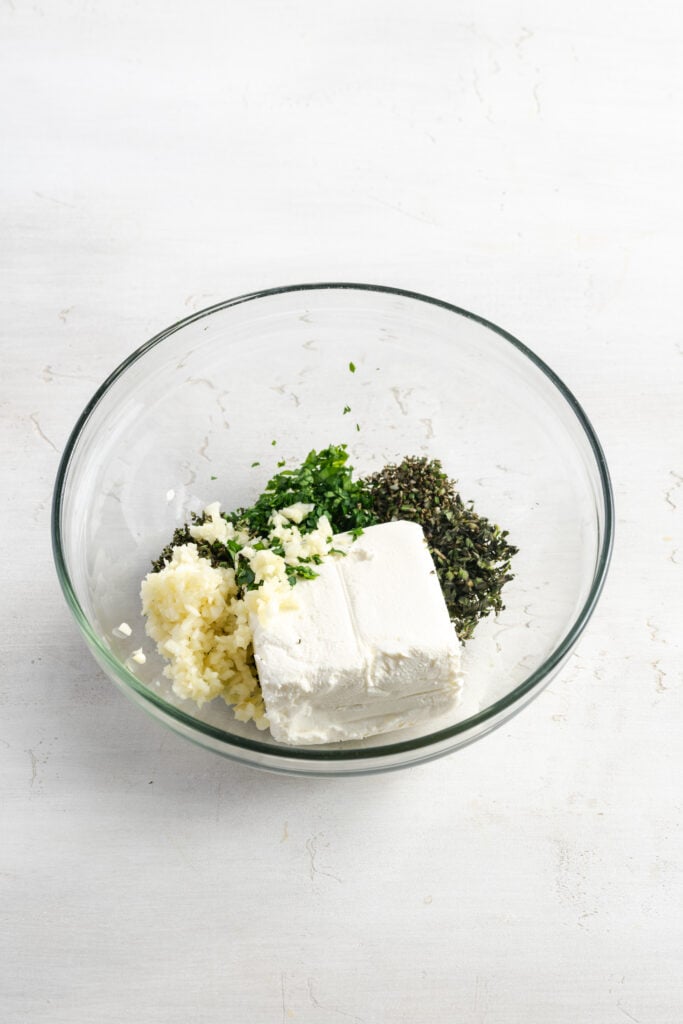 ingredients for cream cheese chicken stuffing mixture in a bowl before mixing together.