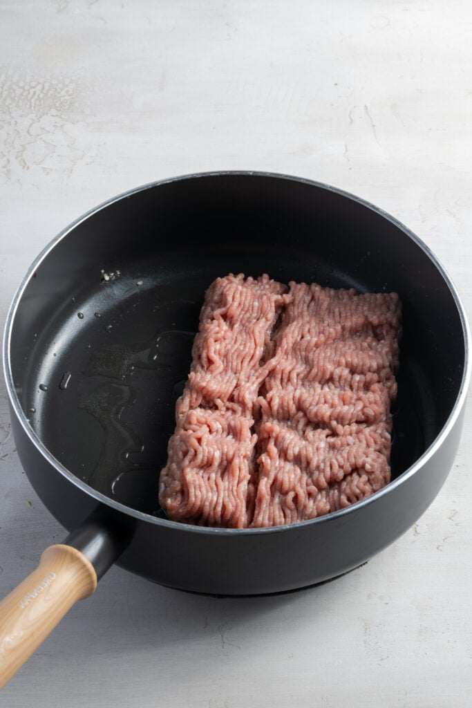 raw ground turkey in a deep skillet.