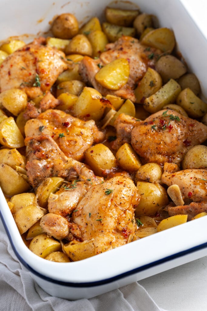 one pot chicken thighs and potatoes in a casserole dish.
