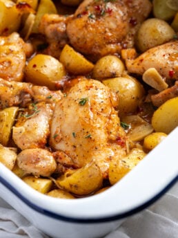 closeup shot of one pan chicken thighs and potatoes after roasting.