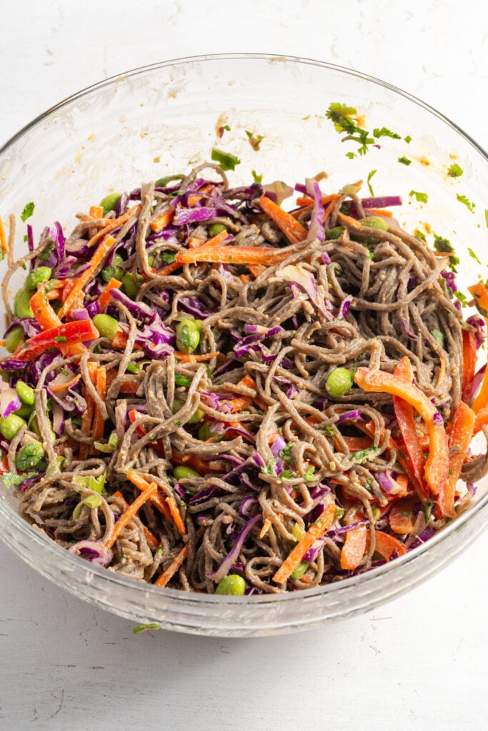 thai peanut noodle salad after mixing the veggies, noodles, and dressing together.