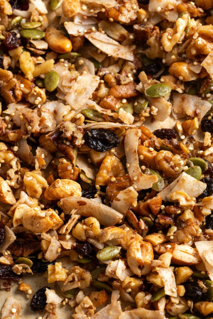 closeup shot of homemade grain-free granola with nuts, seeds, quinoa, coconut flakes, maple, and vanilla.