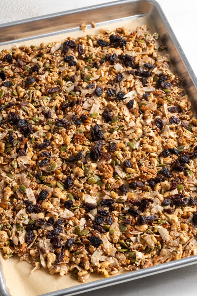 grain free granola on the baking sheet after mixing in the dried fruit and continuing to bake until golden and crisp.