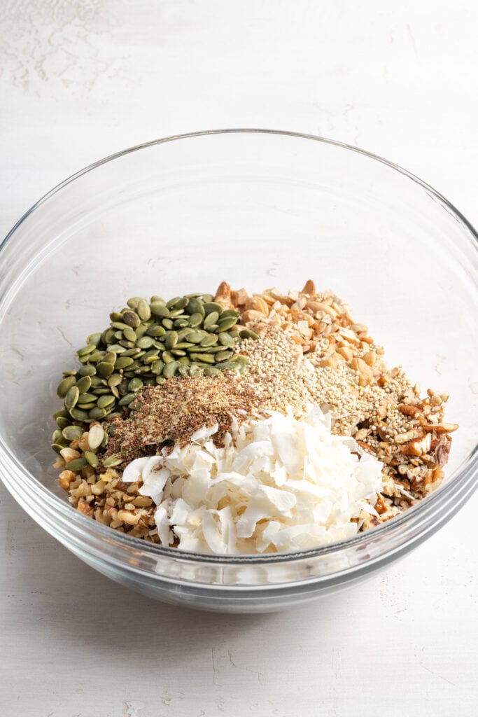 dry oat-free granola ingredients added to a mixing bowl before mixing.