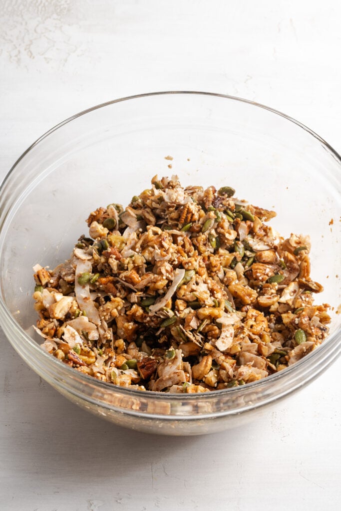 grain free granola mixture in a bowl after tossing with the wet ingredients.