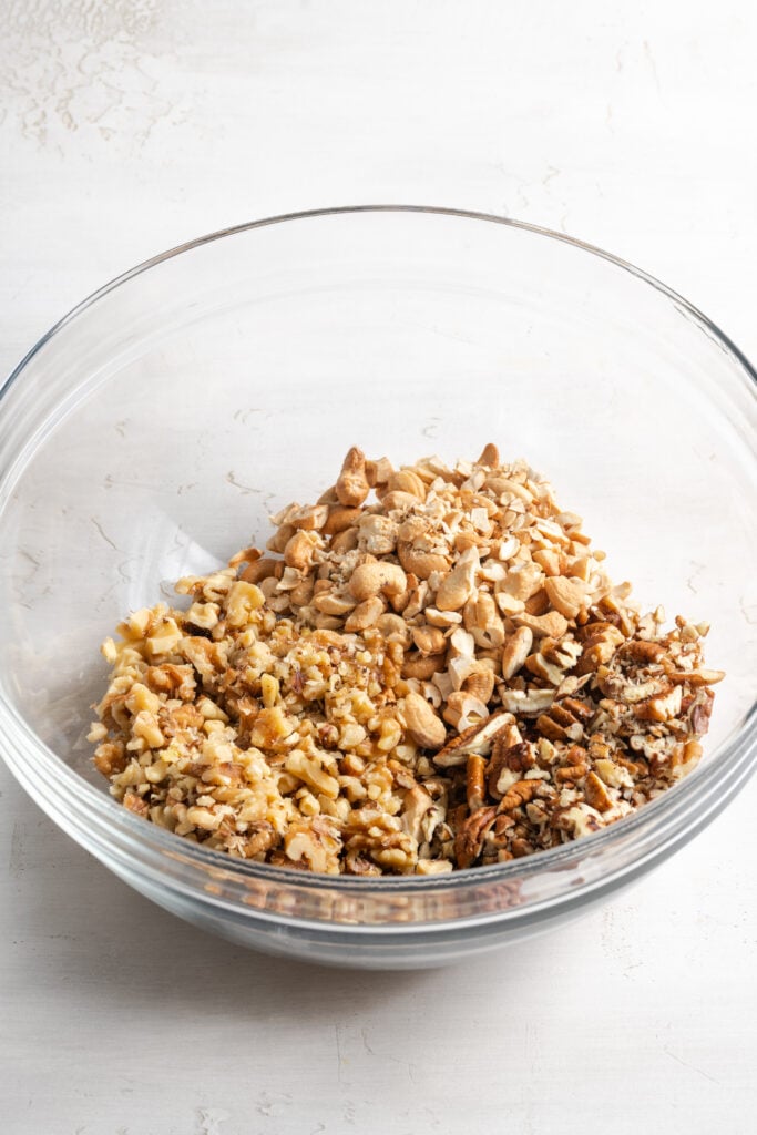 chopped pecans, walnuts, and cashews in a bowl.