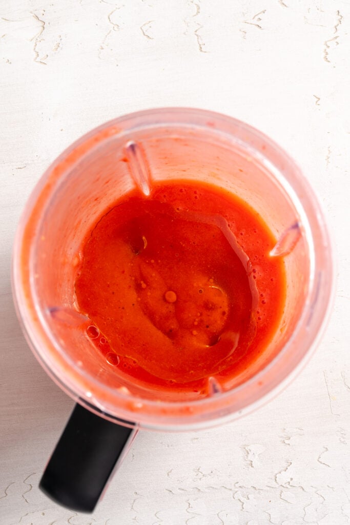 strawberry vinaigrette in the base of a blender after blending.