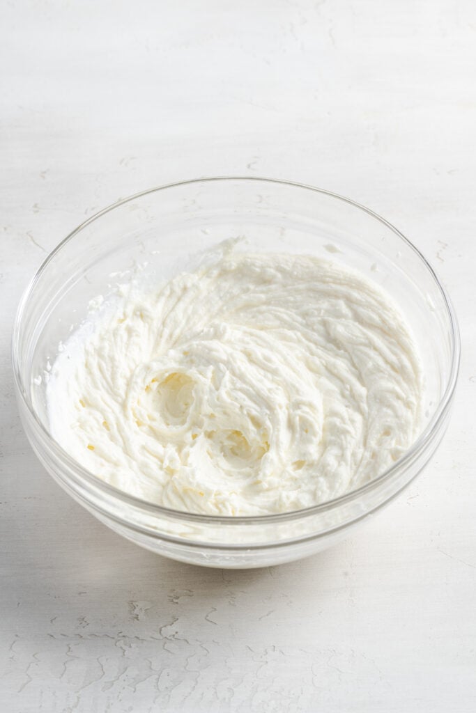 whipped ricotta in a mixing bowl after blending.