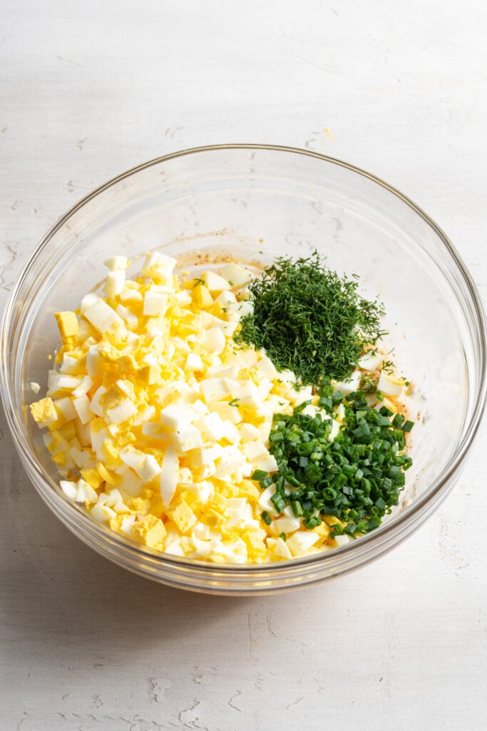 chopped eggs and herbs added to the bowl with the cottage cheese dressing.
