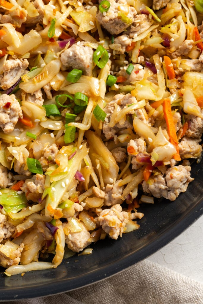 hyper closeup shot of turkey egg roll bowl mixture in the skillet.