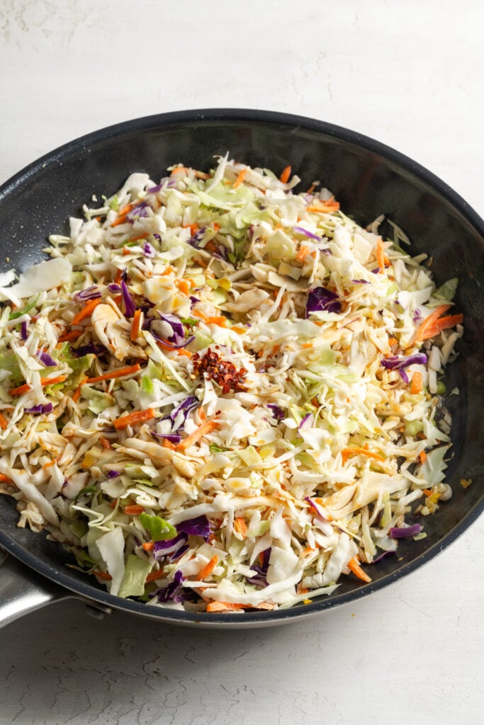coleslaw mix added to the skillet to saute with the aromatics.