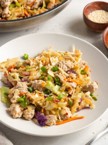 45 degree angle shot of a white pasta bowl filled with a serving of turkey egg roll in a bowl.