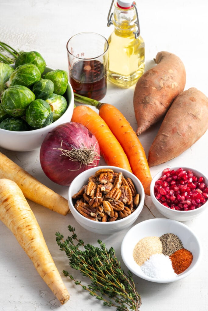 ingredients for roasted fall vegetables recipe measured out on a white table.