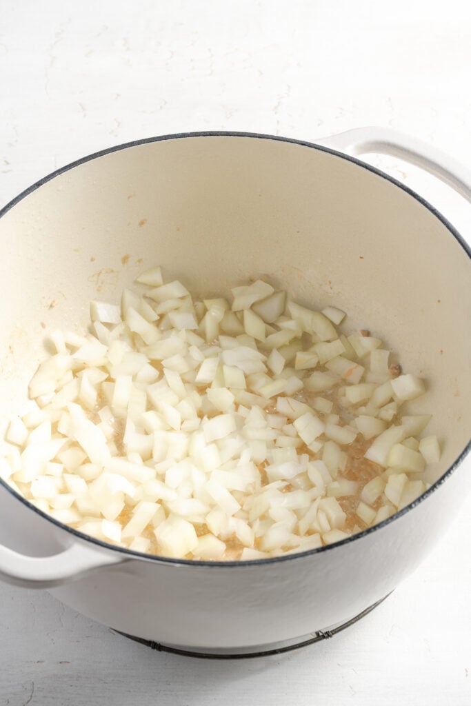 onions sautéing in oil after removing the browned turkey.