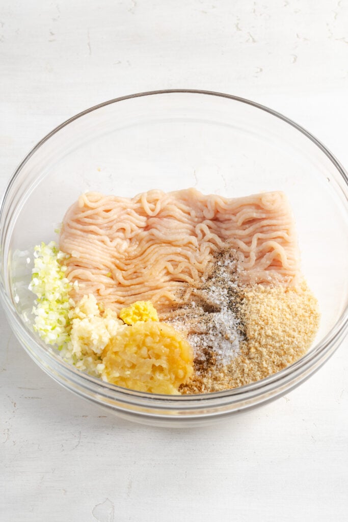 raw pineapple teriyaki chicken meatball mixture ingredients in a mixing bowl.