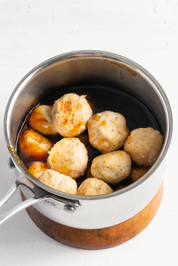 pineapple chicken meatballs added to the saucepan with the pineapple teriyaki sauce.