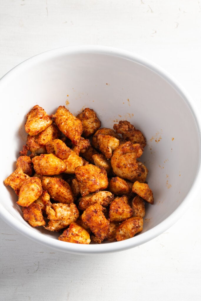 cooked chicken bites in a mixing bowl before adding the buffalo sauce.