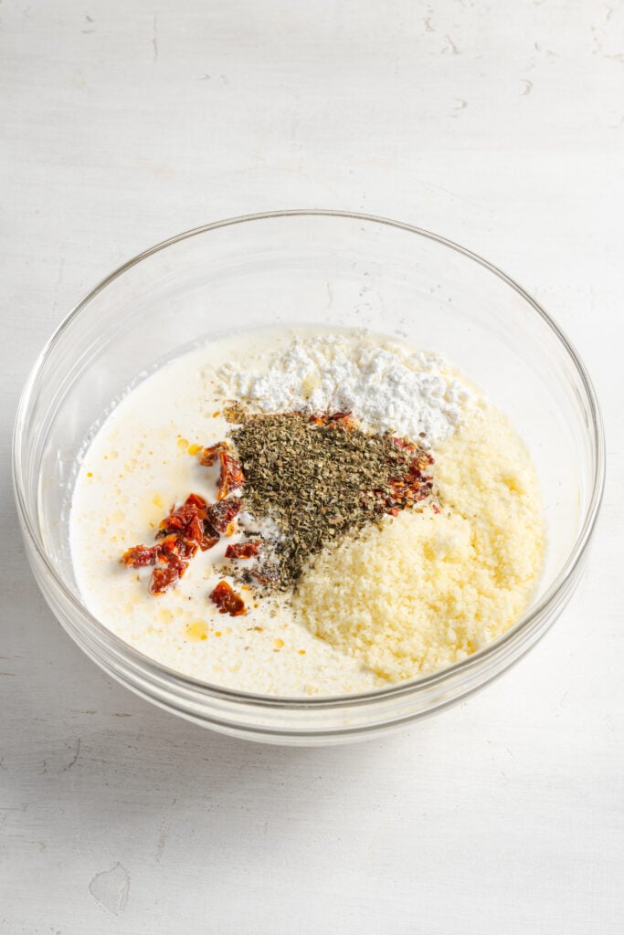 ingredients for the tuscan chicken sauce added to a mixing bowl.