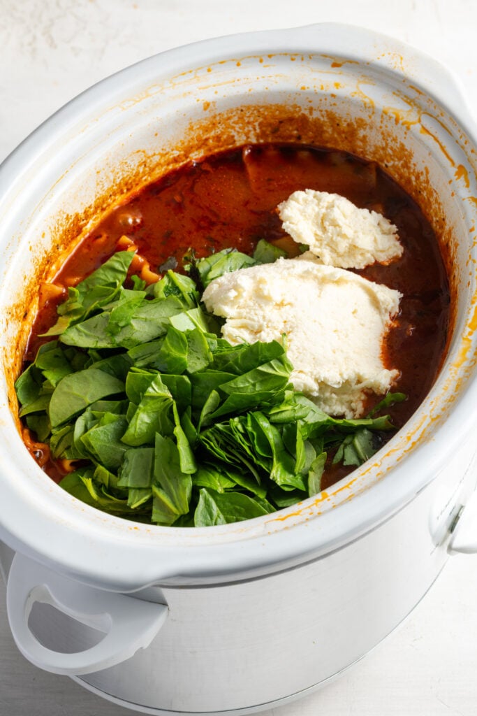 spinach and ricotta cheese added to the slow cooker.