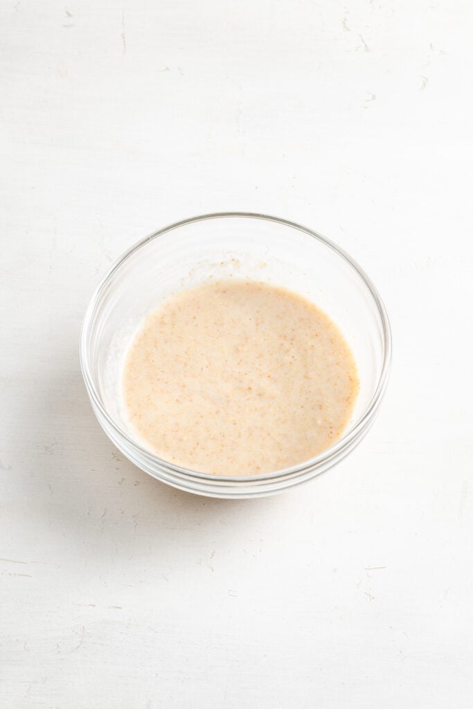 breadcrumbs and milk mixed together in a small bowl for meatball panade.