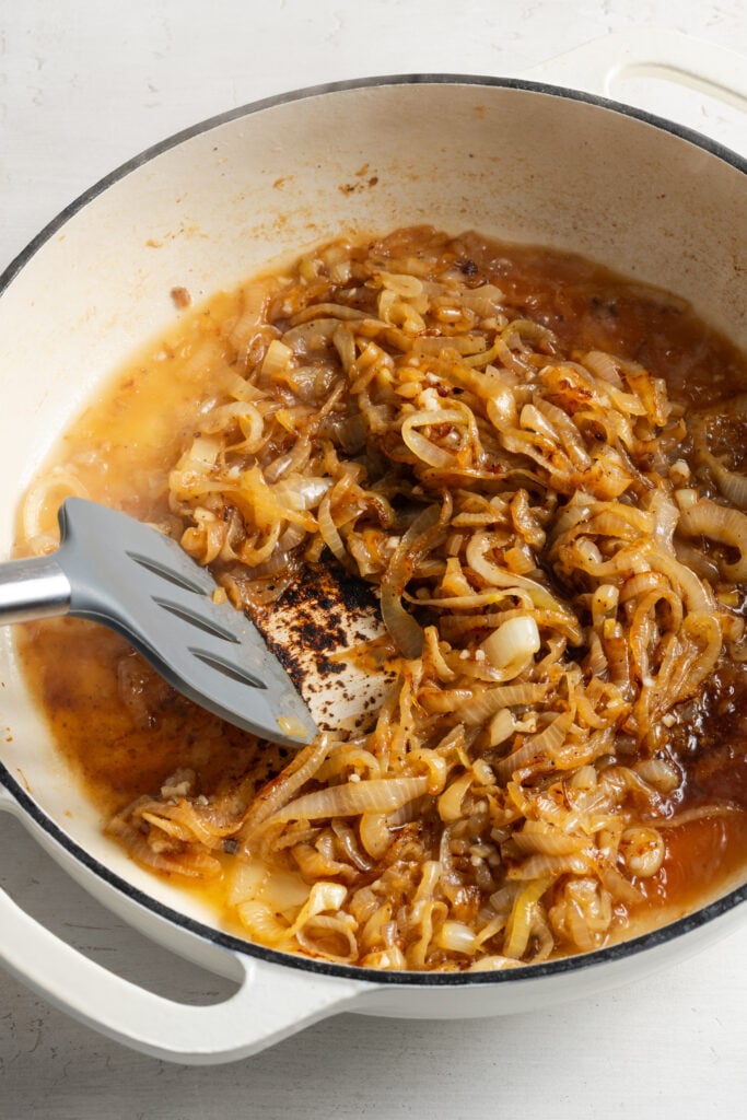 pan with the onions after adding the wine to deglaze the pan with a silicone spatula scraping up the fond.