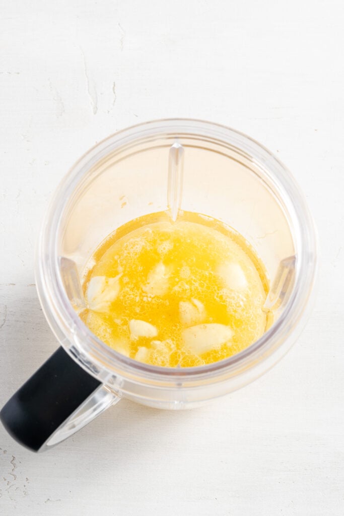 garlic mojo sauce ingredients added to a blender.
