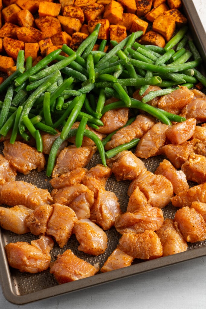 green beans and chicken chunks added to the sheet pan with the sweet potatoes before baking.