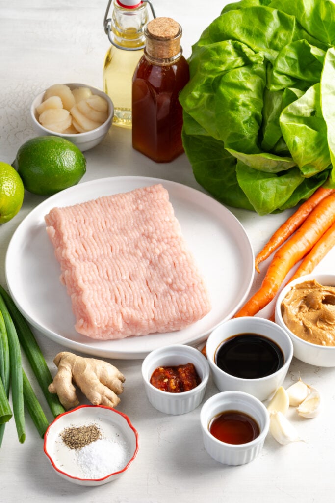 ingredients needed to make Asian ground turkey lettuce wraps recipe measured out on a white table.