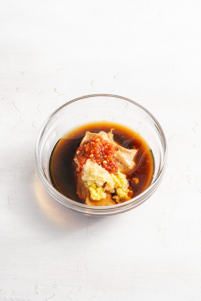 peanut sauce ingredients added to a small mixing bowl.