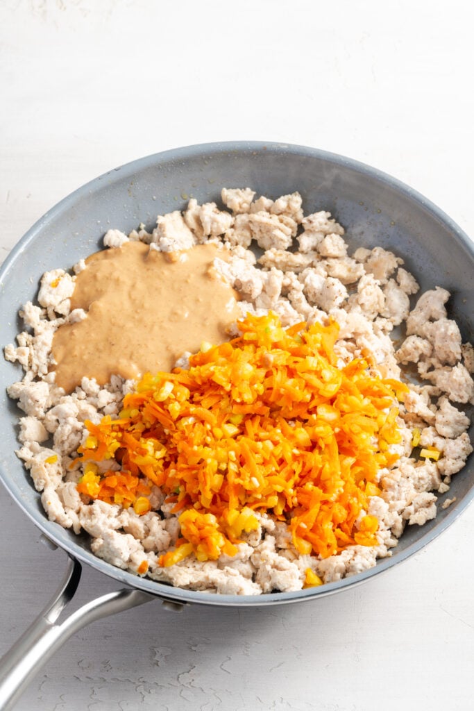 sauteed veggies and peanut sauce added to the pan with the browned turkey meat.