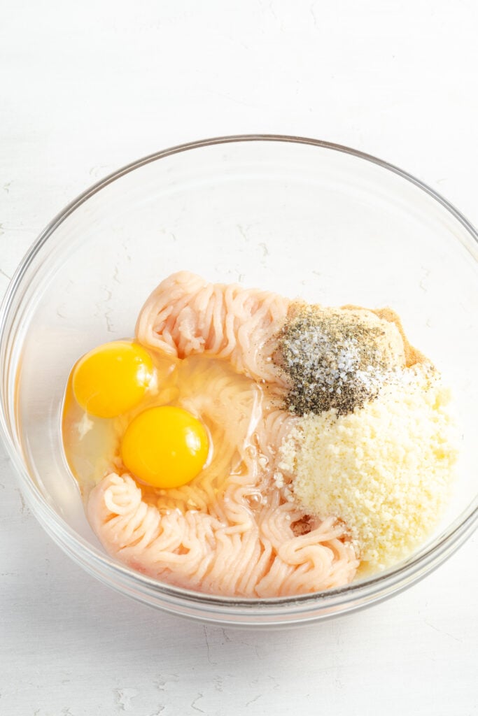 eggs, ground chicken, parmesan and seasonings in a mixing bowl.