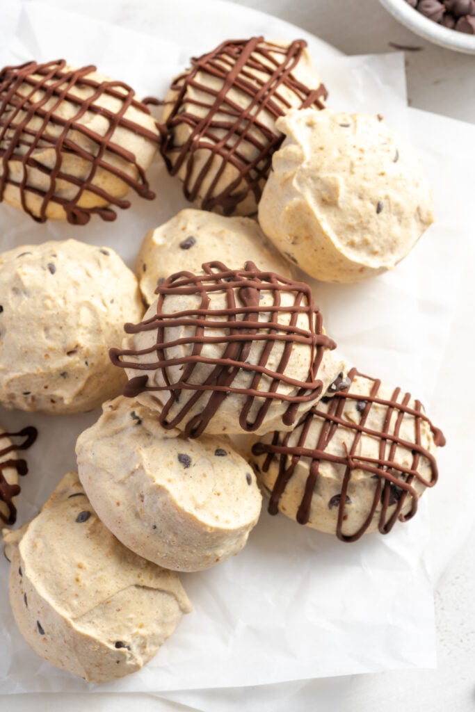 closeup shot of chocolate drizzled frozen greek yogurt peanut butter energy bites.