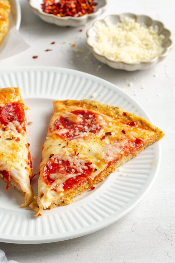 two slices of pepperoni pizza made with ground chicken pizza crust.