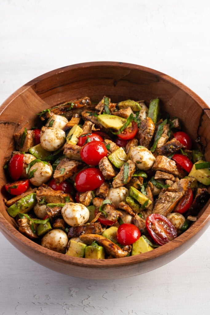 tossed chopped caprese salad with chicken.