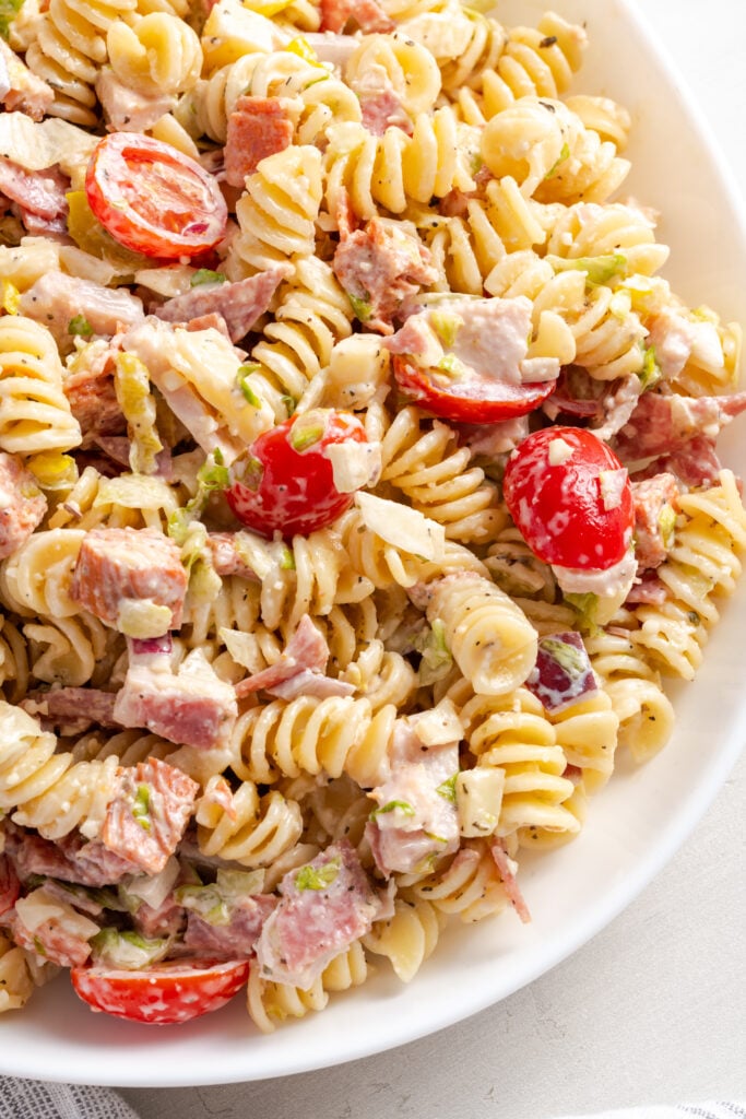 hyper closeup overhead shot of a serving platter of grinder style Italian pasta salad.