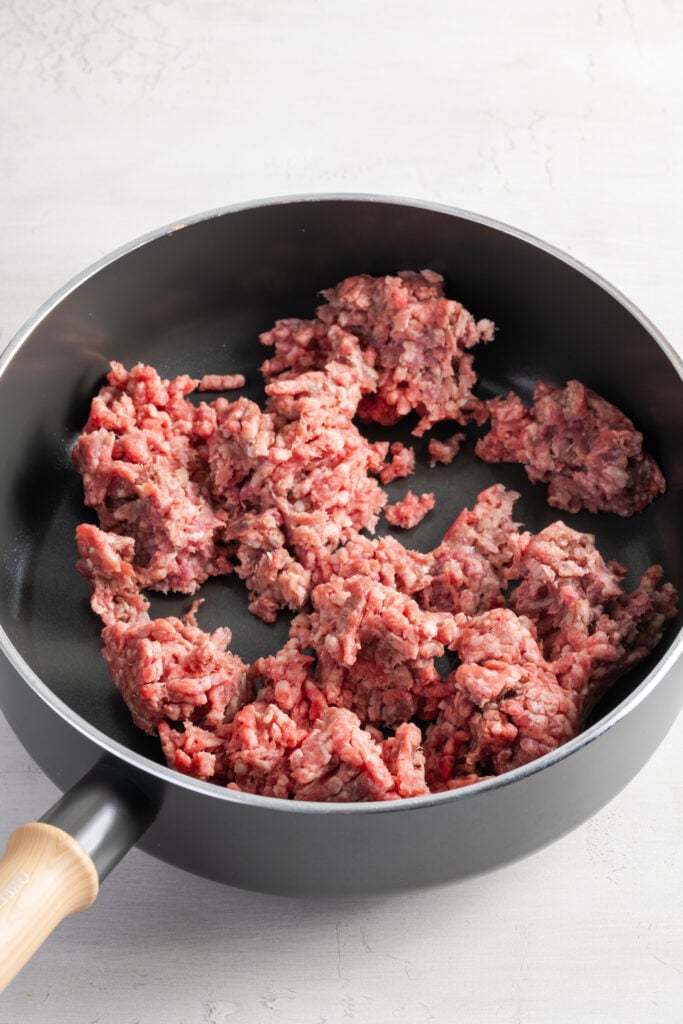 ground beef browning in a skillet.