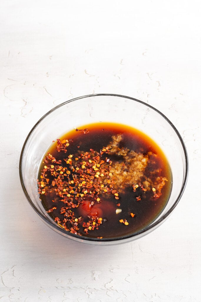 sesame chicken sauce ingredients added to a small mixing bowl.