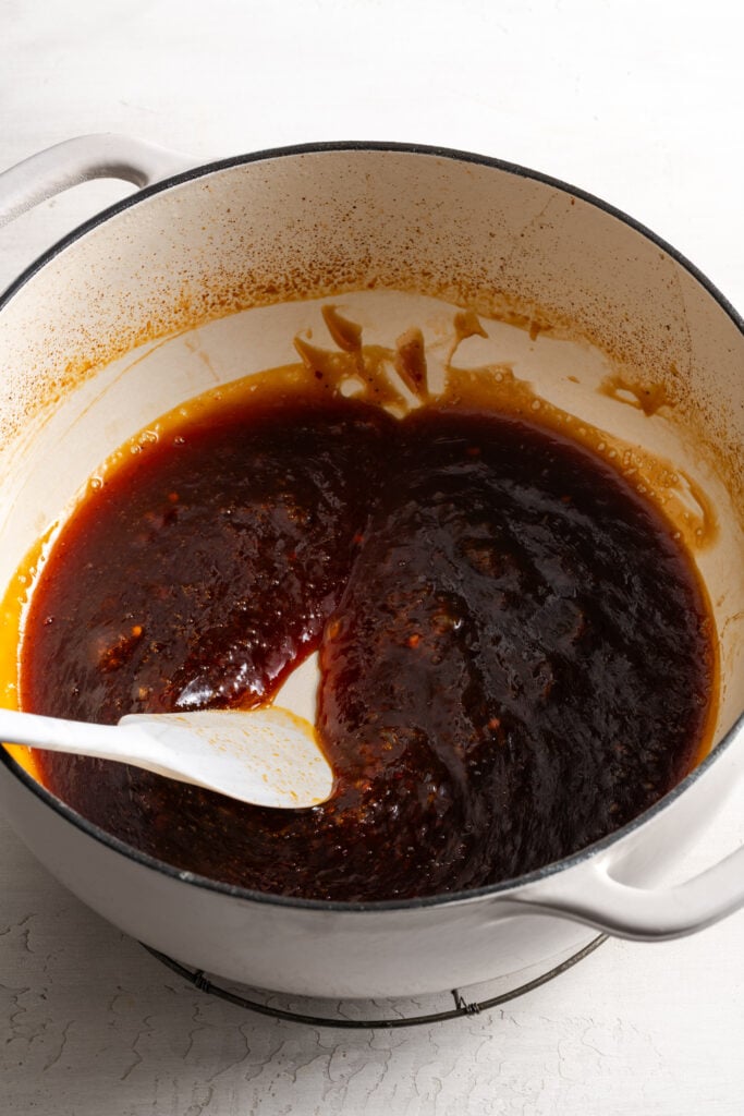 sticky sesame sauce being reduced in a dutch oven.